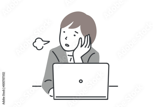 デスクワーク中にため息をつくスーツを着た女性