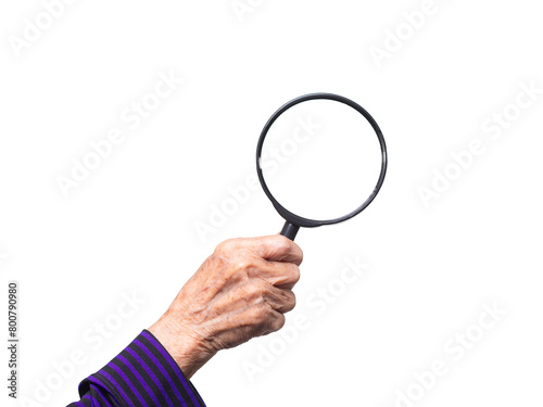 Close-up of an old woman's hand holding a magnifying glass against a transparent background.
