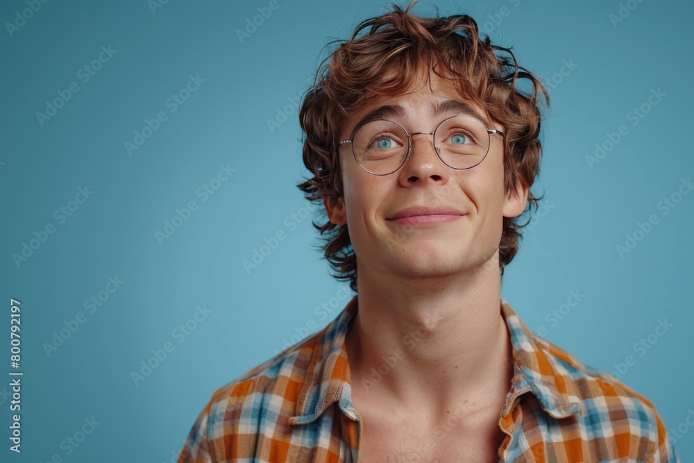Portrait of a handsome young man in glasses on a blue background Portrait of a handsome young man in glasses on a blue background
