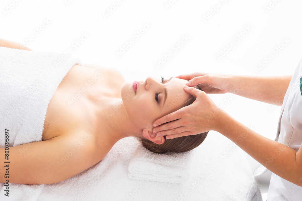 Young woman getting massaging treatment over white. Spa, healthcare and recreation concept.