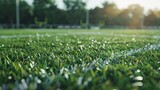 An empty American football field, with focus on the grass and a slight blur in the background.