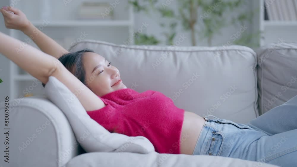 Asian woman resting at home on couch, feeling exhausted after work, lacking energy, or overworked, too tired, and lacking motivation Asian woman resting at home on couch, feeling exhausted after work, lacking energy, or overworked, too tired, and lacking motivation