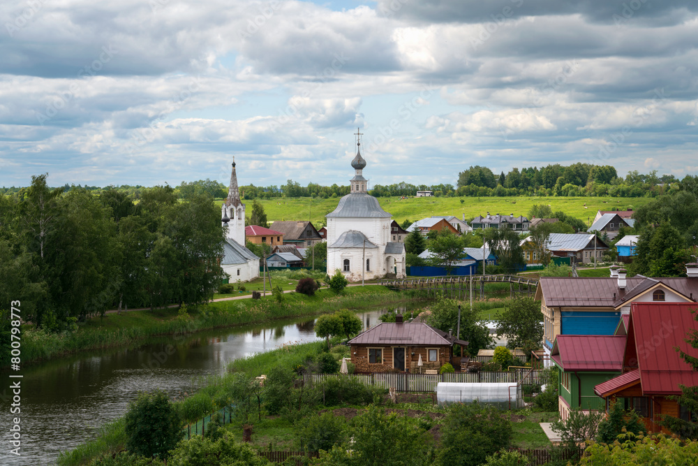 Panoramic view of the Kamenka River and the Church of the Epiphany of Christ (Epiphany Church) in Kozhevennaya Sloboda on a sunny summer day, Suzdal, Vladimir region, Russia