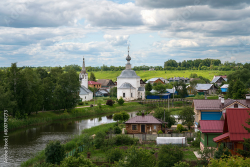 Panoramic view of the Kamenka River and the Church of the Epiphany of Christ (Epiphany Church) in Kozhevennaya Sloboda on a sunny summer day, Suzdal, Vladimir region, Russia photo