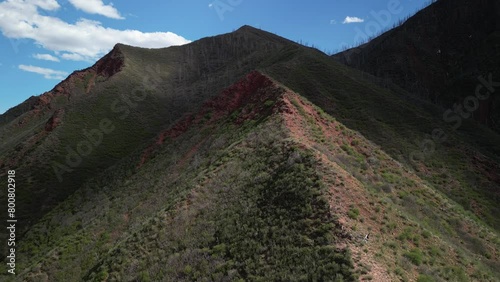 Aerial along green mountain ridge line above Glenwood Springs Colorado in springtime photo
