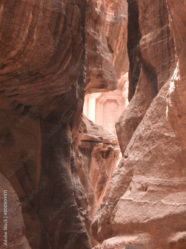 The Treasury  Al Khazn is visible in the gap between the rocks in the Al Siq Gorge of the Petra Historical Reserve in the city of Wadi Musa in Jordan