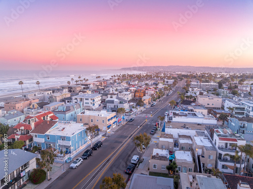Obraz na płótnie Aerial view of colorful sunrise sky over Mission Beach San Diego with residential vacation homes, villas with nobody on the street w salonie