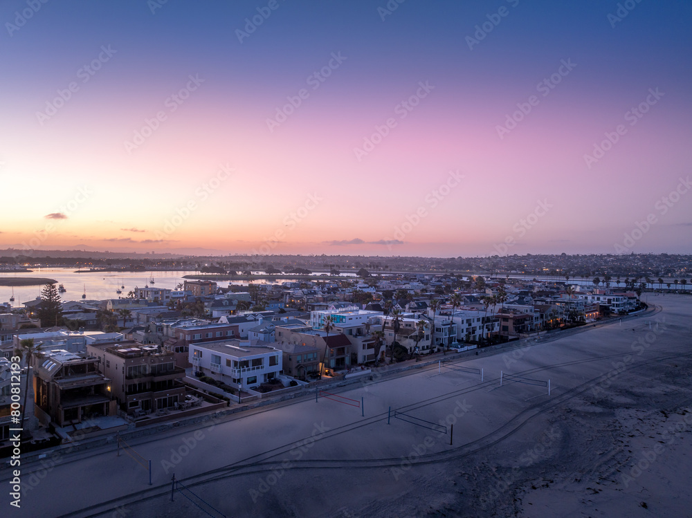 Obraz premium Aerial view of colorful sunrise sky over Mission Beach San Diego with residential vacation homes, villas with nobody on the street