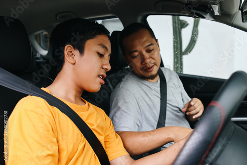 Father Teaching Son Driving a Car 
