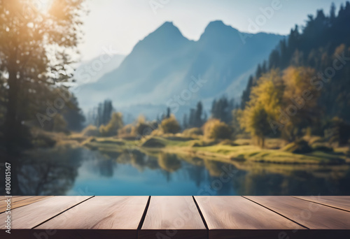 Wooden table top with a scenic view of mountains and a river in a lush valley during sunrise.