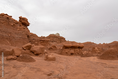 Scenic view on unique eroded sandstone hoodoo rock formations at Goblin Valley State Park, Utah, USA, America. Orange rocks called goblins which are mushroom-shaped rock pinnacles. Canyon hike trail