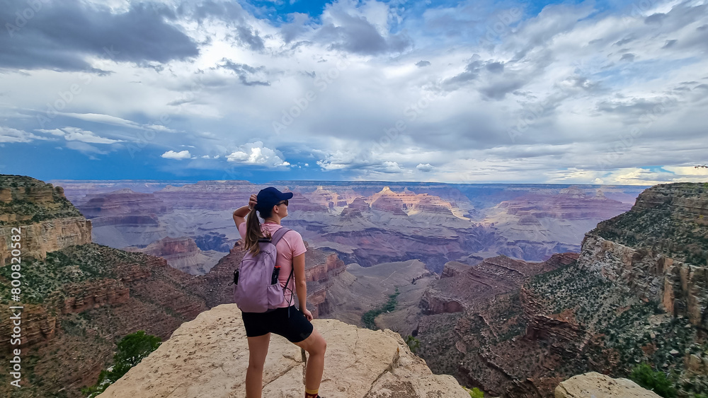 Rear view of woman with hiking backpack standing in a rock on Bright ...