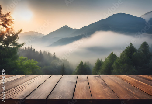 Wooden table overlooking a misty mountain landscape at sunrise, with layers of hills and lush forests.