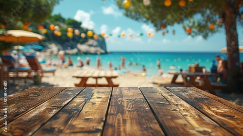 A vacant wooden table overlooking a lively beach party, inviting guests to gather for seaside festivities. © Piyaphorn