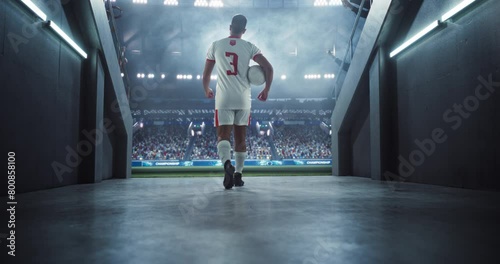 Triumphant Tunnel Walk by an European Football Player in White Uniform Entering a Sold Out Soccer Arena Before a Championship Match. Footballer is Welcomed Like Superstar by International Soccer Fans photo