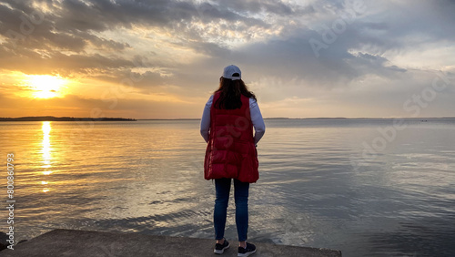 Woman Walking Along Lake Mendota at Sunset in Madison Wisconsin photo