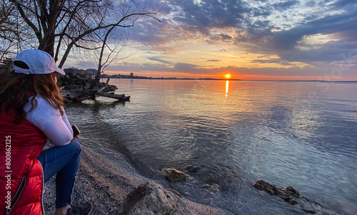 Woman Walking Along Lake Mendota at Sunset in Madison Wisconsin