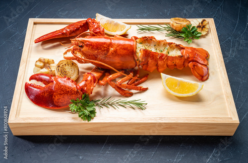 Grilled Lobster with Cheese on wooden plate, Grilled Canadian Lobster on wooden background.