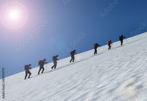 Large groups of people climbing to the top in harsh winter conditions