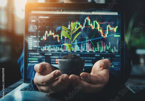 Image depicts hands nurturing a small plant against a backdrop of bullish stock market charts, symbolizing growth and investment photo