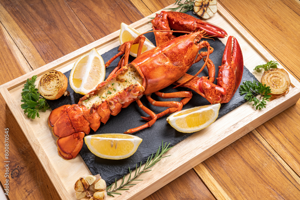 Grilled Lobster with Cheese on black plate, Grilled Canadian Lobster on wooden background. Grilled Lobster with Cheese on black plate, Grilled Canadian Lobster on wooden background.