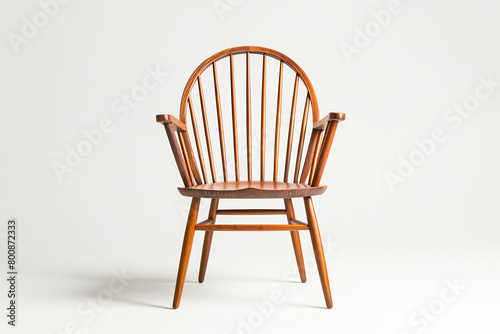 A minimalist Windsor chair portrayed in high definition against a solid white background, isolated on solid white background.