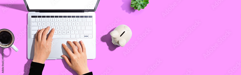 Laptop computer with piggy bank - flat lay Laptop computer with piggy bank - flat lay