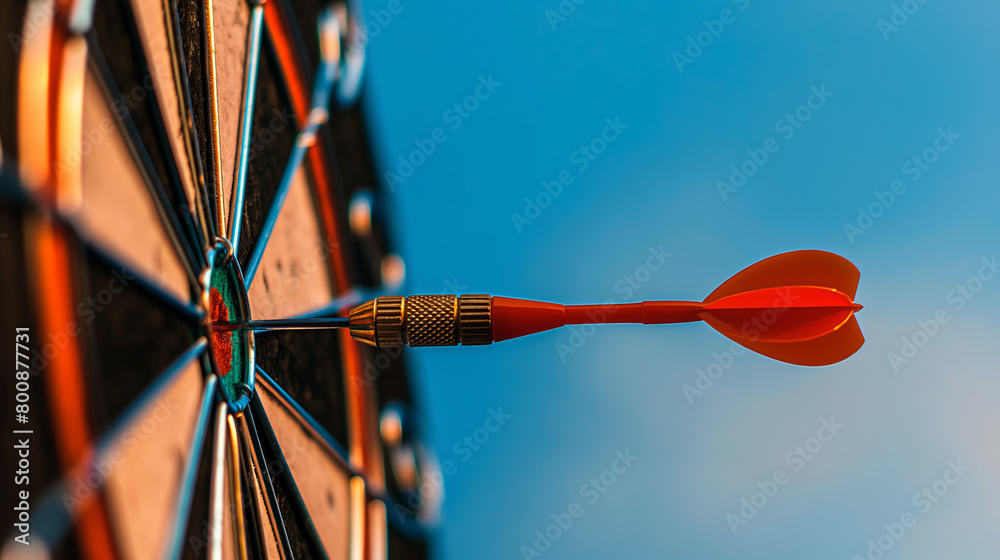 The ultimate symbol of accuracy, a dart in the center of a target with a clear blue backdrop The ultimate symbol of accuracy, a dart in the center of a target with a clear blue backdrop