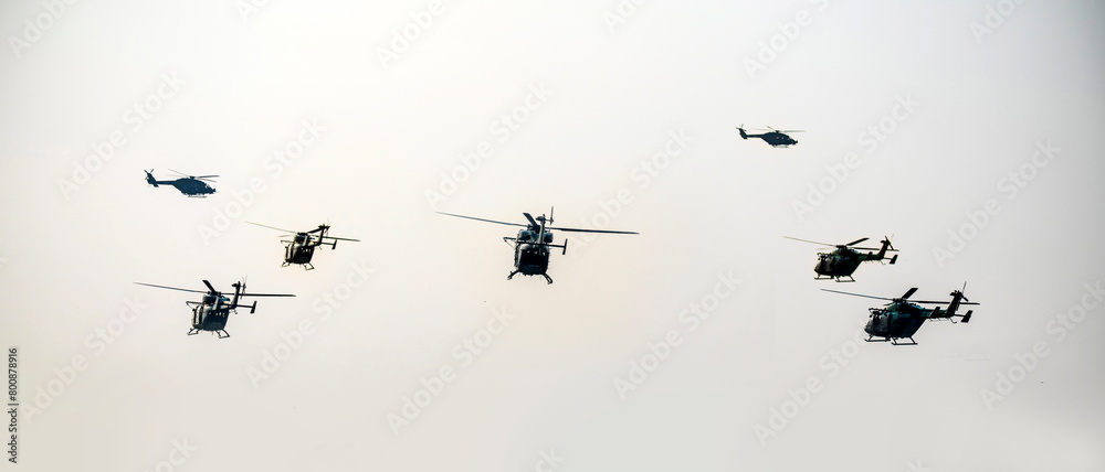 Obraz premium A group of helicopters are flying on isolated sky