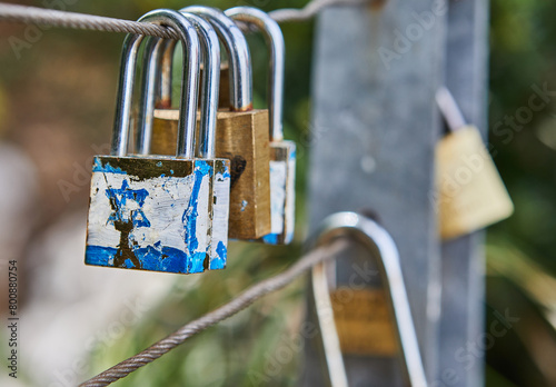 Castles symbolize unity and love forever. Locks hang on fence ropes in park. Tradition of locking locks throwing the key into the river will make their love last forever
