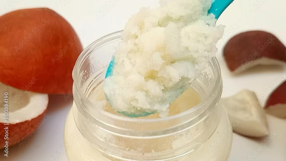 Spooned out a spoonful of hard coconut oil from a jar on white background, micro close up Spooned out a spoonful of hard coconut oil from a jar on white background, micro close up