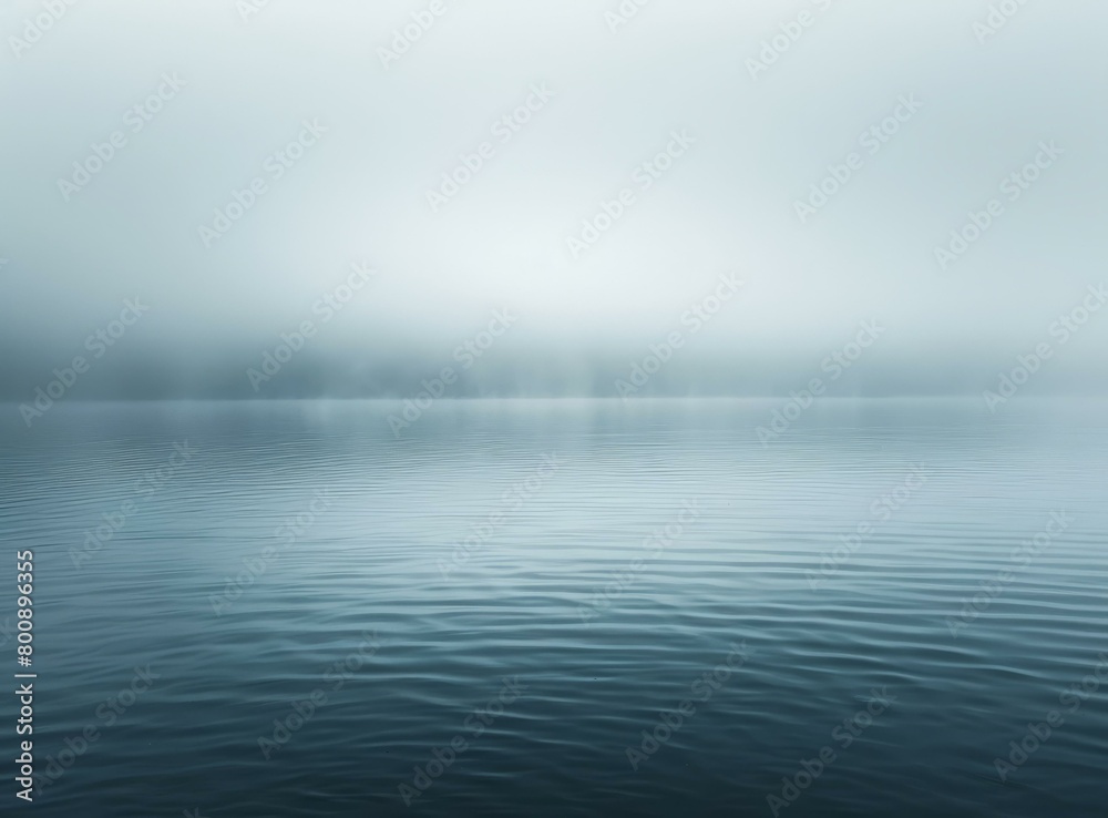 Obraz premium Foggy lake with distant mountains