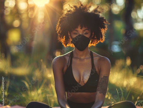 Young African-American woman wearing a black mask outdoors photo