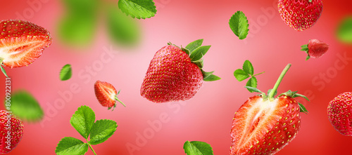 strawberry pieces flying on red background. Reference for design.
