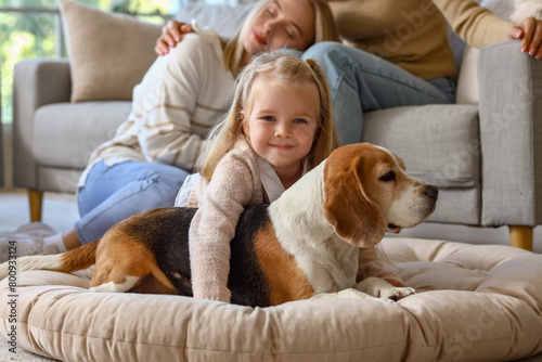 Little girl with cute dog at home photo