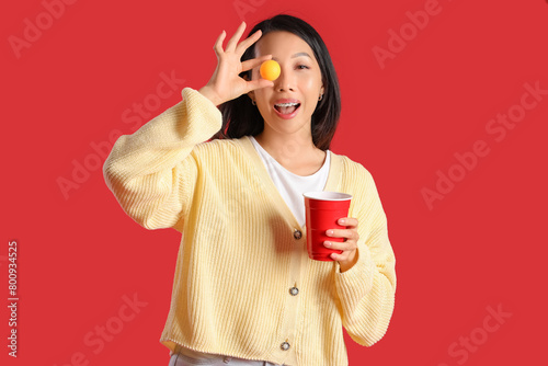 Young Asian woman with beer...