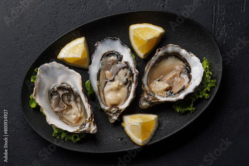 Fresh oysters with lemon on plate