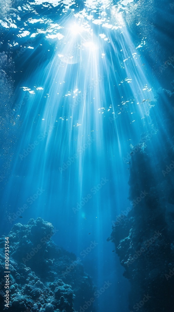 The image is of a beautiful blue ocean with sunlight shining through the water