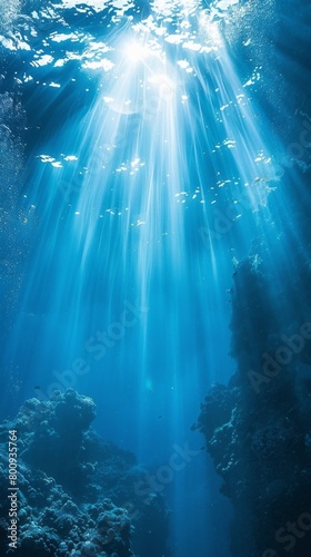 The image is of a beautiful blue ocean with sunlight shining through the water