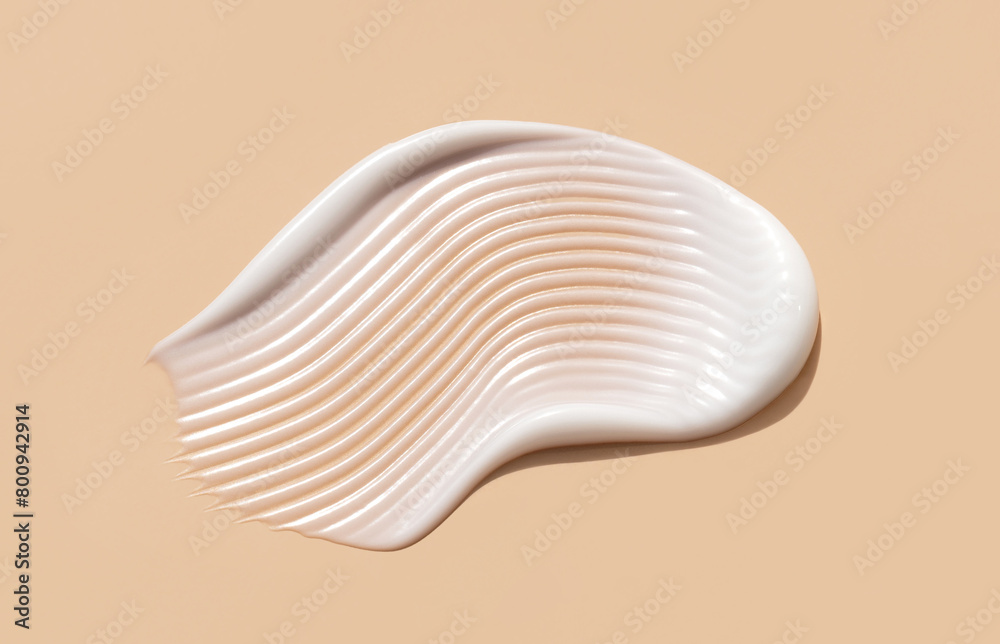 cosmetic smear of creamy texture on a beige background cosmetic smear of creamy texture on a beige background