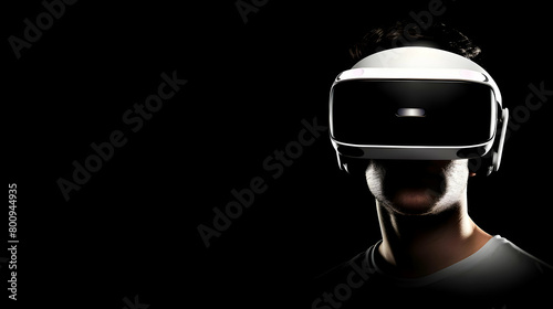 Man wearing virtual reality (VR) goggles. Black background. Copy space.