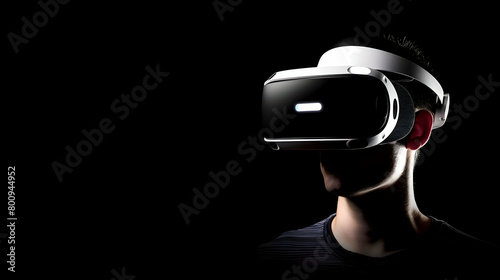 Man wearing virtual reality (VR) goggles. Black background. Copy space.