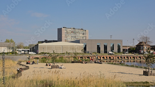 Houtdok, beach in an old dock of the harbor of Ghent, with historical brick walls and industrial and apartment buildings around  photo