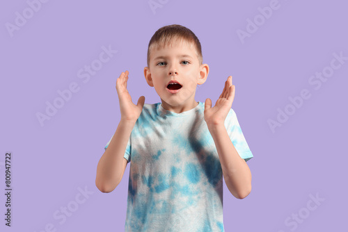 Shocked little boy on purpl...