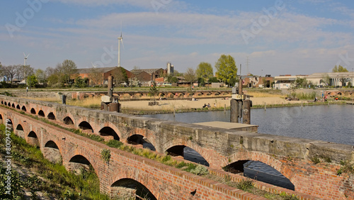 Houtdok, beach in an old dock of the harbor of Ghent, with historical brick walls and industrial and apartment buildings around  photo