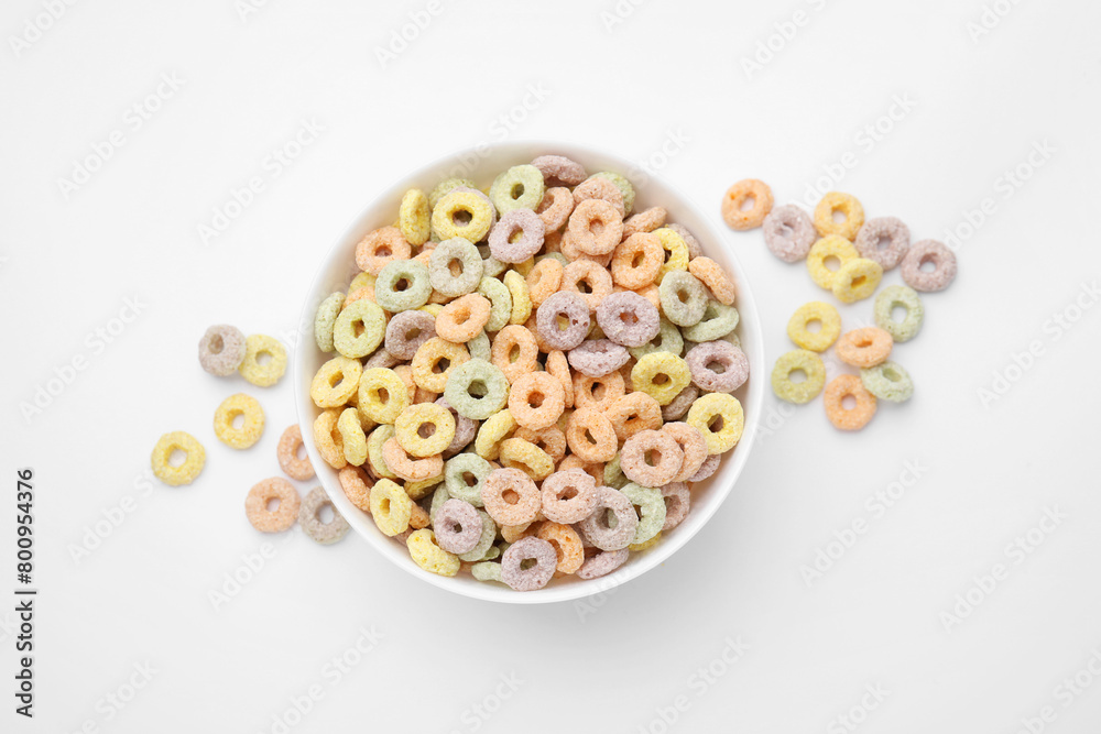 Tasty cereal rings in bowl on white table, top view Tasty cereal rings in bowl on white table, top view