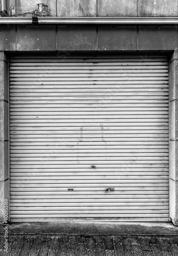 Closed steel shutter door of warehouse, storage or storefront for metal door background and textured. © torjrtrx