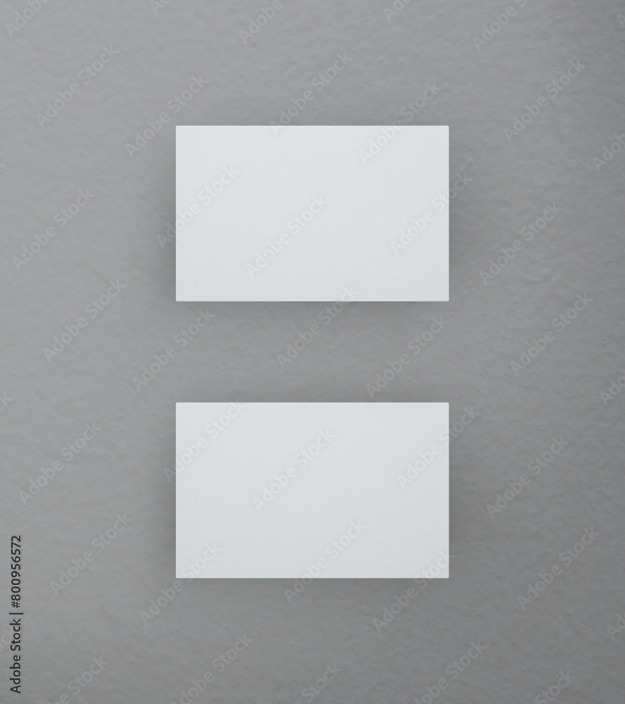 Blank white business name card mockup on grey background, Top view, 3D rendering Blank white business name card mockup on grey background, Top view, 3D rendering