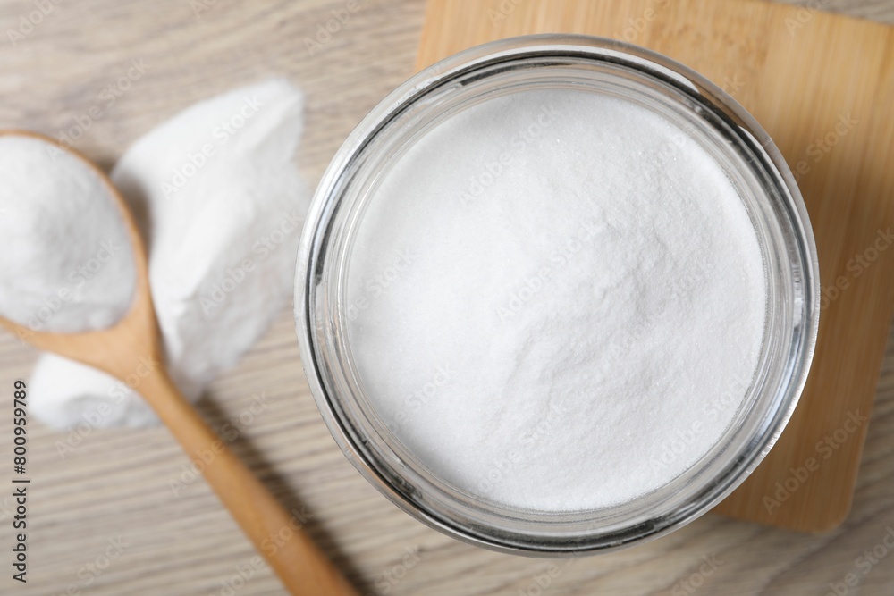 Baking soda in glass jar on wooden table, top view Baking soda in glass jar on wooden table, top view