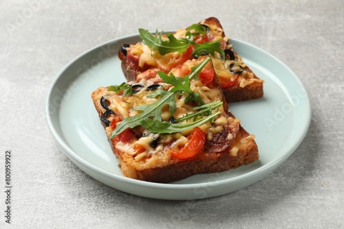 Tasty pizza toasts served on grey table